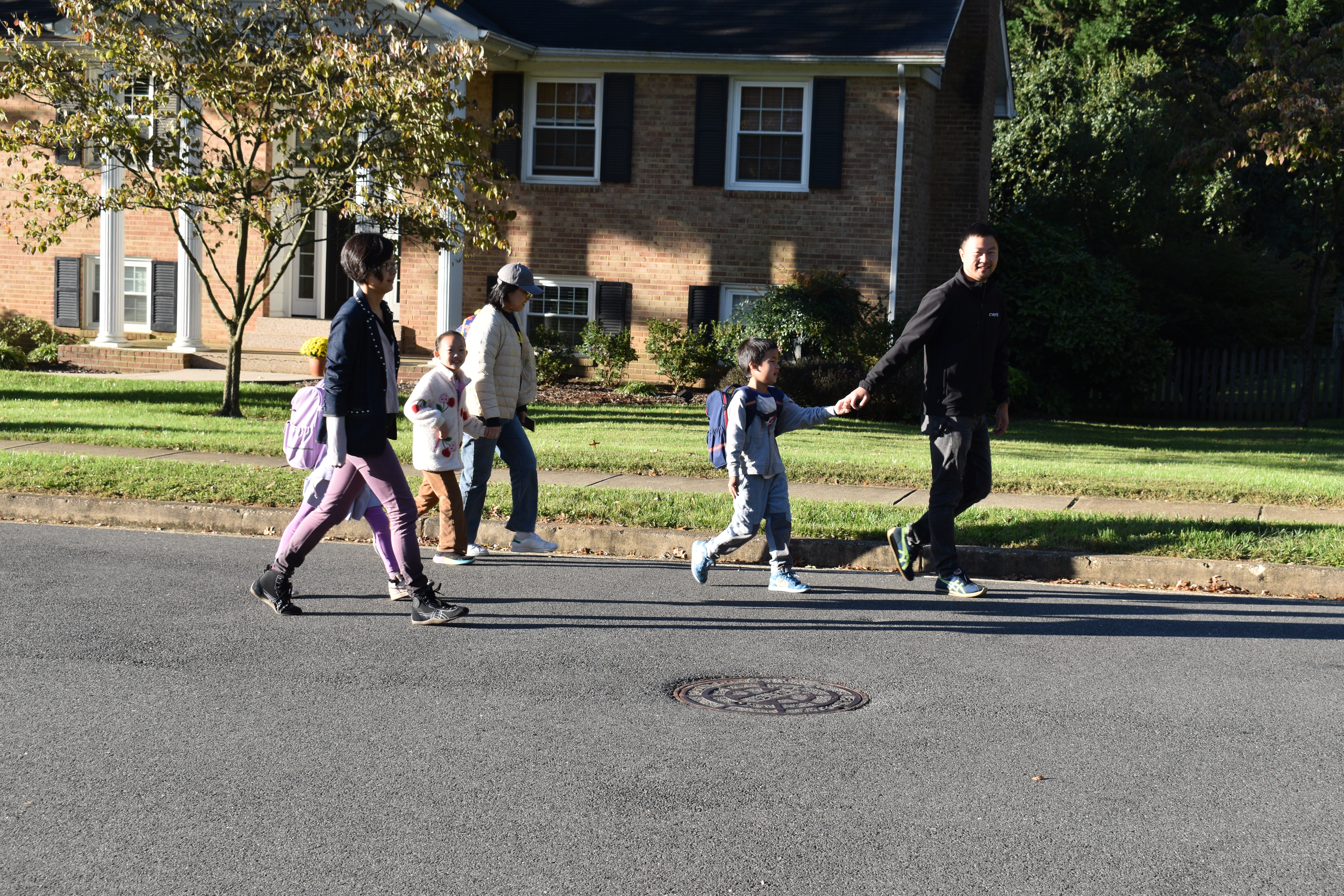 families walking on sidewalk